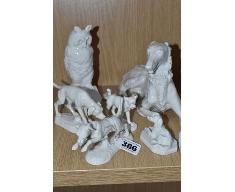 A GROUP OF FIVE NYMPHENBURG WHITE PORCELAIN DOGS AND ONE OWL FIGURE, comprising an owl reading a book, embossed with the mott