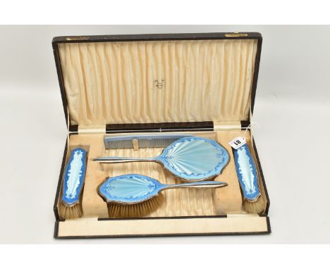 A CASED SILVER AND BLUE GUILLOCHE ENAMEL VANITY SET, comprising of a hand held mirror, hair brush, two clothes brushes, each 