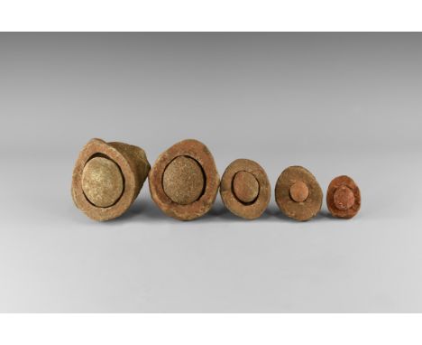 Group of five wind-rounded pebbles with their individual hollowed out 'nests', from the Kalahari Desert region, western Afric
