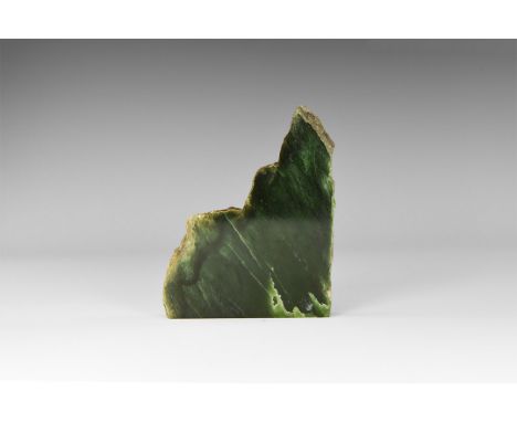 A 15mm thick slice of rich green nephrite jade, polished on one side; in old white card tray. From the historic ‘Victorian Mu