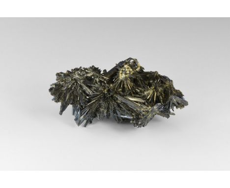 A radiating mass of stibnite crystals from Romania, slightly dulled on the topside from natural chemical erosion, bright on t