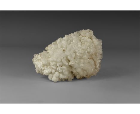 A fine specimen of cave-growth calcite forming numerous spherical aggregates, giving the appearance of popcorn. From the hist