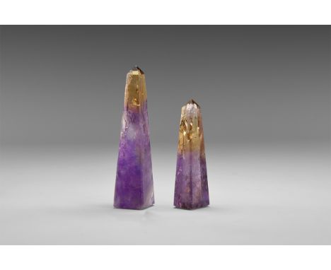 A pair of finely carved ametrine (a natural mix of amethyst and citrine) obelisks from Bolivia, both showing amethyst in the 