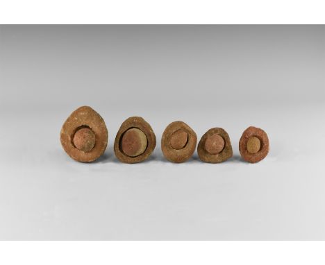 Group of five wind-rounded pebbles with their individual hollowed out 'nests', from the Kalahari Desert region, western Afric