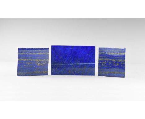 A group of three gem-quality, rectangular lapis lazuli plaques from Afghanistan illustrating the types of occurrence, polishe