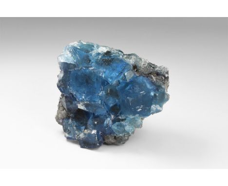 A rare specimen of blue fluorite from the Tri-state Area of the USA, with several large stepped cubes and a number of smaller