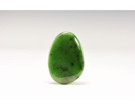 A ovoid touchpiece of polished, fine green Russian nephrite jade, in old white card tray with old Gregory, Bottley and Lloyd 