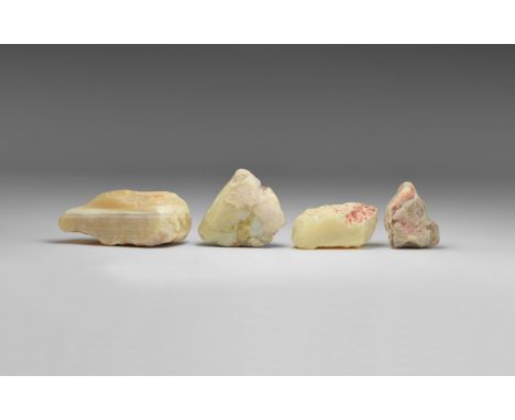 A group of four pieces of gem-quality, white-base opal, from Australia, with thin layers of precious opal between layers of p