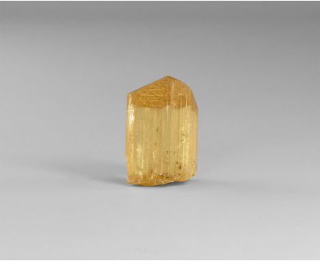 A gem-quality yellow scapolite crystal with unusually fine crystallization, from Handeni, Tanzania; in old white card tray. F