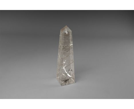 A fine obelisk carved from rutilated quartz, with several dozen needles of red-brown rutile, and a number of reflective veils