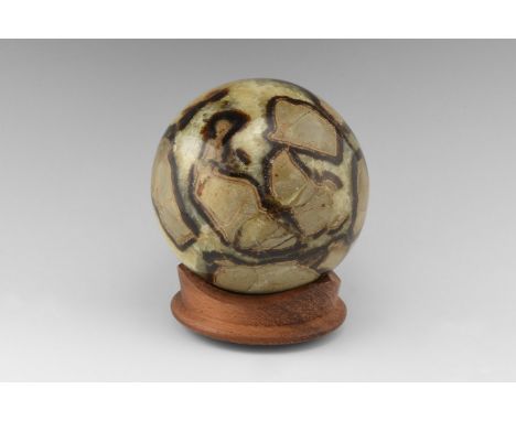 A large sphere cut from a septarian concretion, formed by a yet unknown process, the cracked limestone material is filled fir