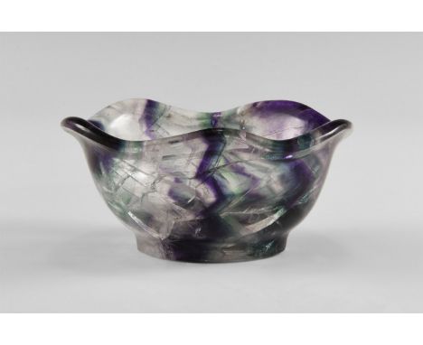 A Chinese-carved bowl in rich purple and colourless fluorite, with strong banding and a flared, fluted rim. Found China; from