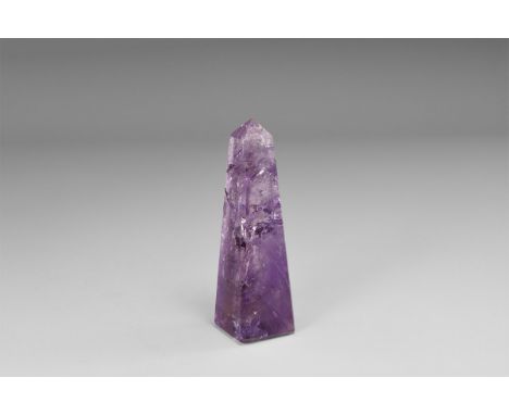 A finely coloured obelisk cut from a single amethyst crystal, with numerous internal features which provide additional sparkl