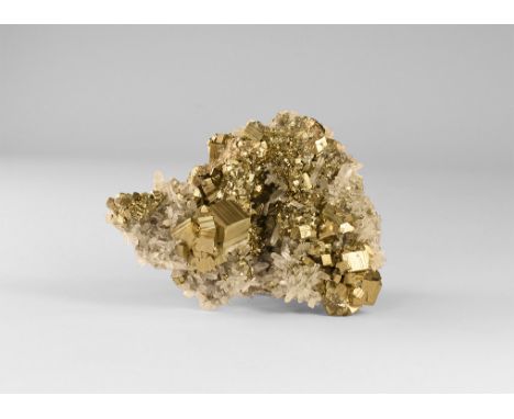 A stunning specimen of well-crystallised milky quartz crystals on lustrous cubic pyrite crystals from Peru, in old white card