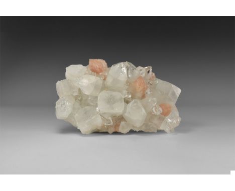 A fine specimen of colourless apophyllite with pink stilbite, from Maharashta, India, with large, well-formed crystals. Found