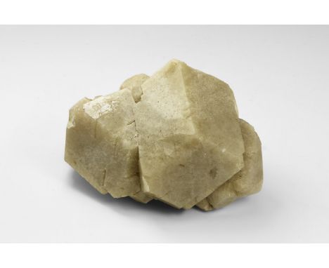 A specimen of grossular garnet with one large and several smaller dodecahedral crystals from Mexico, in old white card tray w