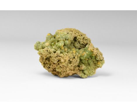 A specimen with green, globular aggregates of adamite, studded with blocky orange crystals of wulfenite, from the classic loc