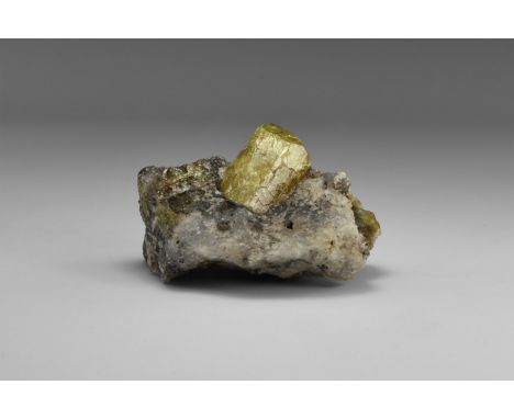 A single crystal of apatite, on a quartz groundmass, with two smaller apatite crystals, from Durango, Mexico, in old white ca