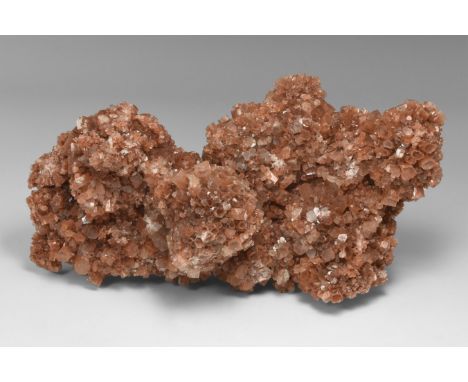 A group of aragonite crystals from Mexico, consisting of hundreds of pseudo-hexagonal crystals growing from a radiating arago