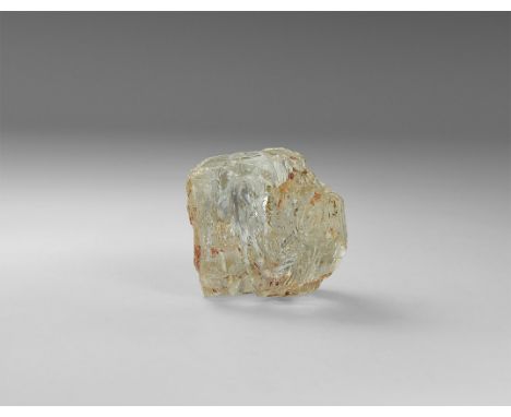 An unusually formed crystal of colourless topaz with stepped face development, with cleavage face 'window' into the interior,