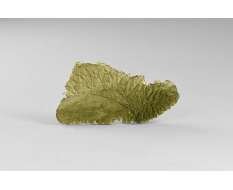 A fine transparent, bottle-green moldavite specimen showing good ablation features, in old white card tray with old Gregory, 