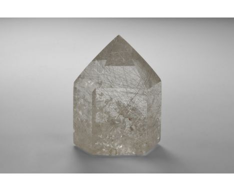 A pointed hexagonal prism cut from very high quality rutilated quartz with numerous golden rutile needles and 'rainbow' refle