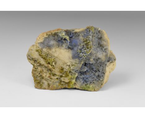 A blue crust of the rare lead phosphate plumbogummite with accessory green pyromorphite, from Cumbria, in old white card tray