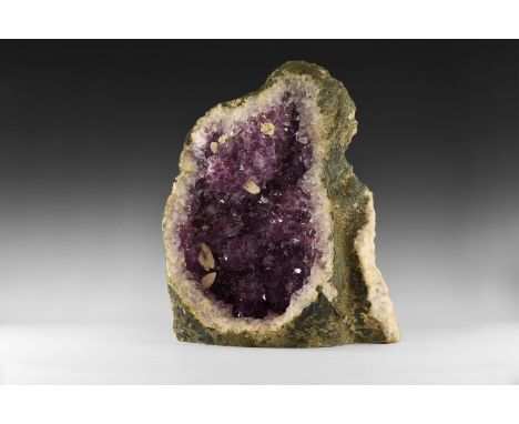 A large amethyst geode section with well-formed and richly coloured amethyst crystals, with several well-formed secondary lar