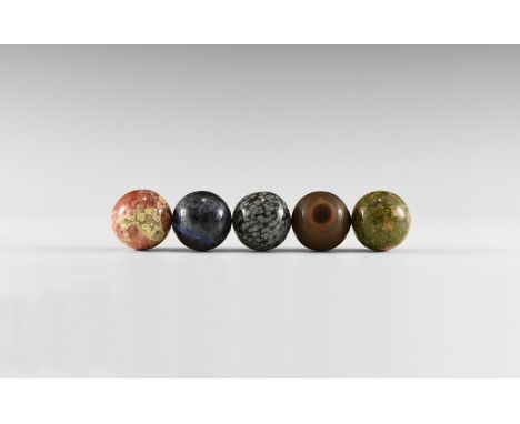 A group consisting of five gemstone spheres, including one each of: tiger iron, brecciated jasper, unakite, sodalite, and sno