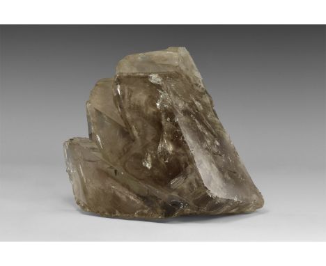 A large unusual occurrence of smoky quartz consisting of three parallel, intergrown crystals, with numerous internal reflecti