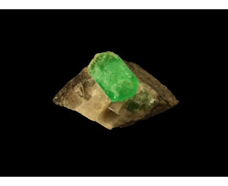 A matrix emerald specimen, with an emerald crystal of approximately 1.5 carats surrounded by calcite, with the top of an addi