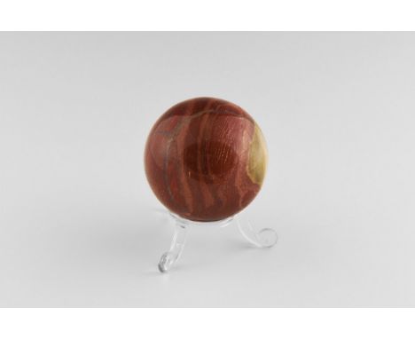 An interesting sphere of banded red jasper, with numerous swirls and layers to the jasper, with thin quartz cross-bands, with