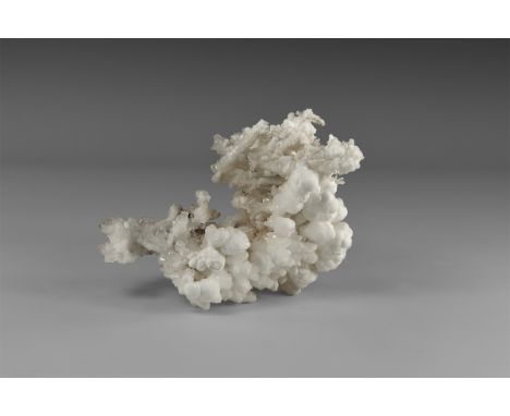 A fine specimen of cave-growth calcite forming numerous spherical aggregates, giving the appearance of popcorn. From the hist