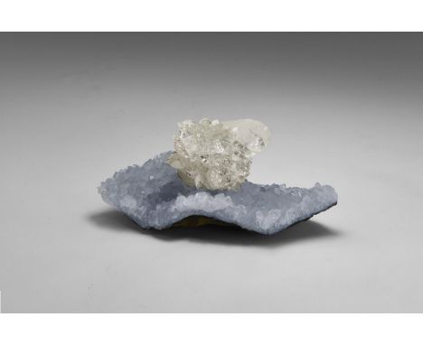 A fine specimen of apophyllite with a sheet of smaller crystals on a thin agate base, and a well-formed and attractive cluste