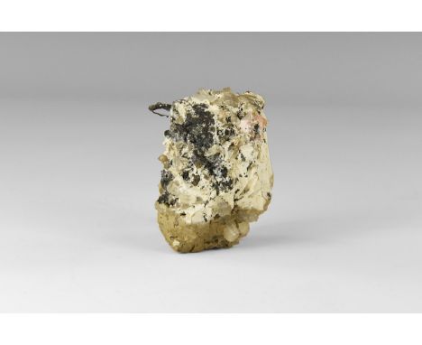 A specimen of wire silver in quartz on a rock matrix, in old white card tray with a detached adhesive tape label reading: ''3
