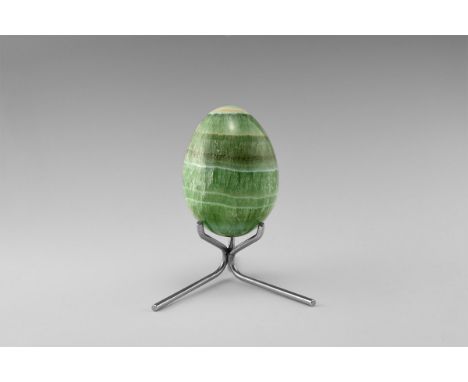 An unusual gemstone egg carved from layered and banded green fluorite, with stand. From the historic ‘Victorian Museum’ colle