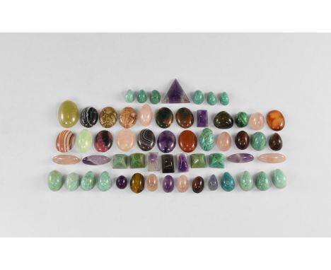 A group of fifty seven gemstone cabochons of varying shapes and sizes mostly cut with high domes, including amazonite, rose q