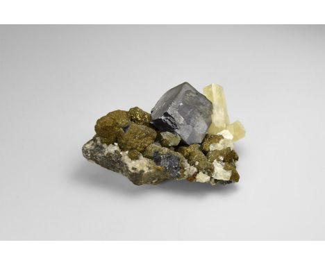 An unusual specimen of galena with chalcopyrite overgrowths, followed by a second phase of galena growth to form a single cub