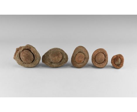 Group of five wind-rounded pebbles with their individual hollowed out 'nests', from the Kalahari Desert region, western Afric