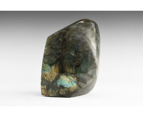 A large polished boulder of labradorite from Madagascar, with rich colour play on most faces, principally blues and golds. Fo