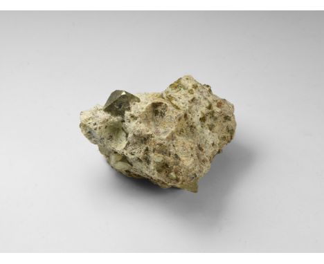 A fine octahedral crystal of pyrite in matrix, the crystal points with pyritohedral tips, and with several cubo-octahedral cr