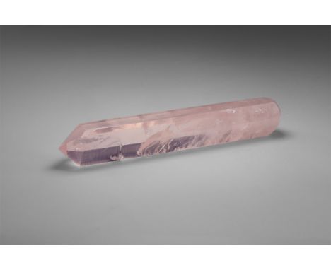 Originally polished as a 'healing wand', this hexagonal rose quartz prism with one pointed end and one rounded end is cut fro