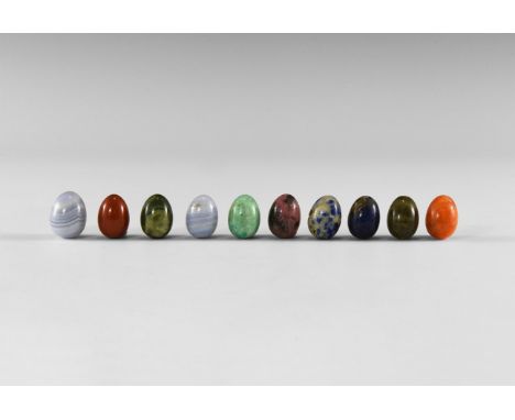 A group of ten gemstone mini-eggs including blue agate, lapis lazuli, sodalite, rhodonite, labradorite, and various agates an