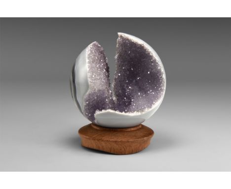 A one-of-a-kind sphere cut from a lilac amethyst-lined agate geode with an antique turned wood stand. From the historic ‘Vict