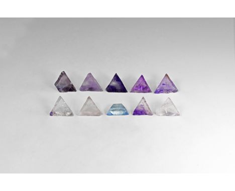 Group of ten of clear to purple and lavender triangular cleaved fluorite crystals, some with strong colour-banding, from the 