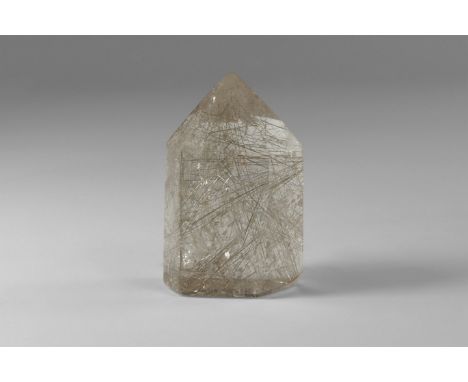 A pointed hexagonal prism cut from very high quality rutilated quartz with numerous golden rutile needles and 'rainbow' refle
