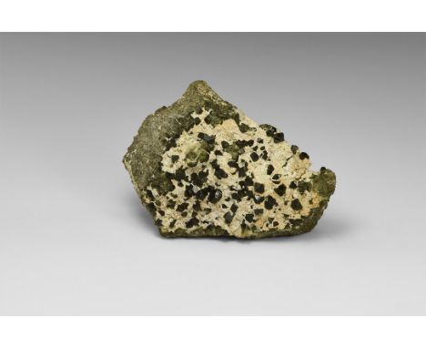 A matrix specimen of epidote on a rock groundmass with calcite encrustation, in old white card tray with Peter Appleton colle