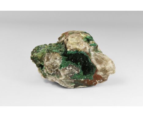 A piece of quartz vein material with several vugs containing fine malachite crystals with well-formed crystals in one major v