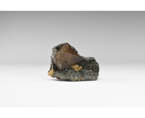 A fine example of specular haematite surmounted by a double-terminated smoky quartz crystal, on botryoidal haematite, from th