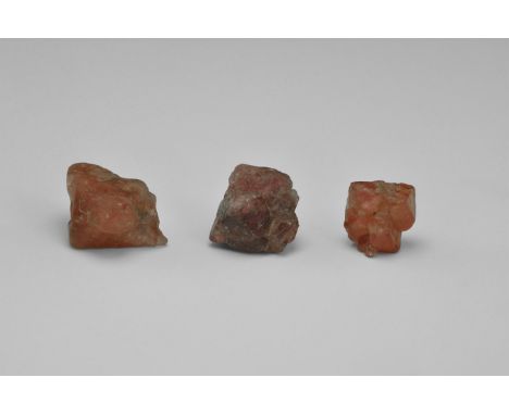 Three octahedral crystals of red spinel, all twinned, from Myanmar, ex Chris Cavey Collection, in old white card tray with ha